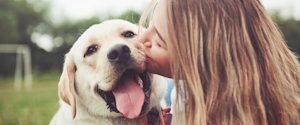 Woman cuddling a dog