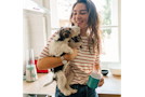 Woman is holding her dog