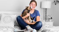 Happy owner holding her cat