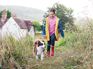 Girl and dog is walking