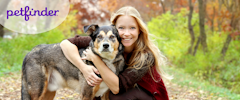 A woman hugging her dog with Petfinder logo