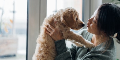 a woman holding her puppy